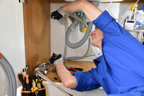 Plumber Replacing Kitchen Drain Pipe